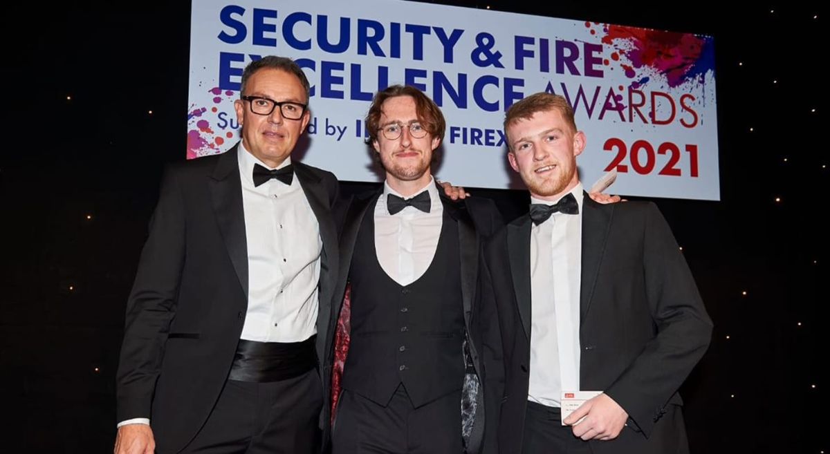 Three men dressed in tuxedos.   Adam Smylie, centre, winner of the Engineer of Tomorrow IFSEC National Competition